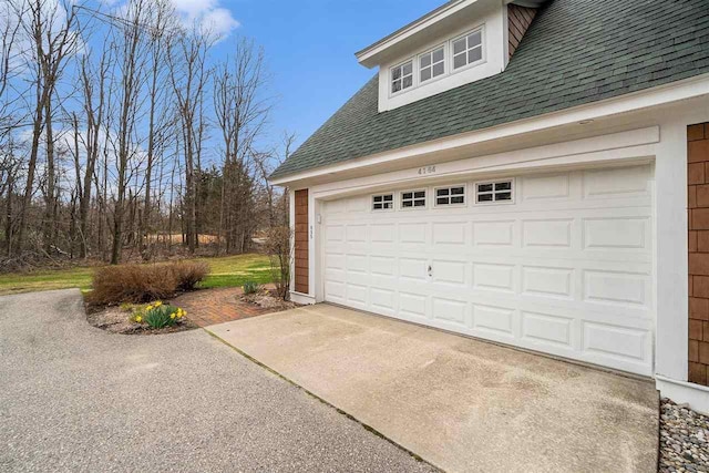 garage featuring aphalt driveway