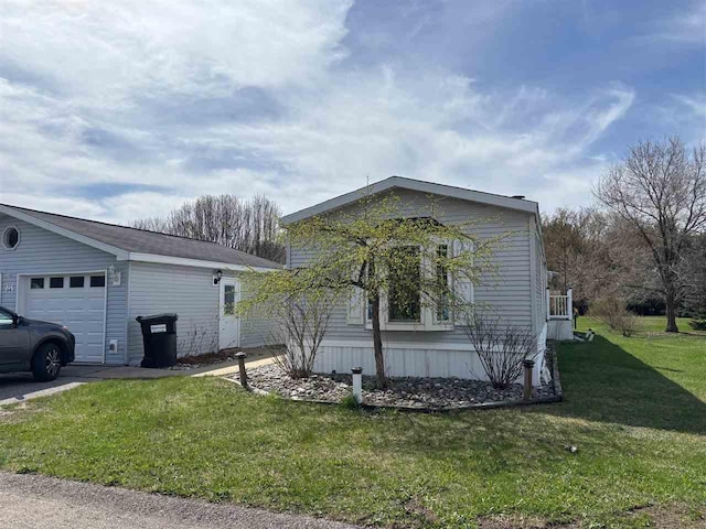 view of front of home with a garage and a front lawn