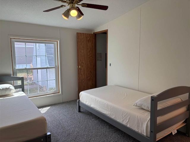 carpeted bedroom with ceiling fan and multiple windows