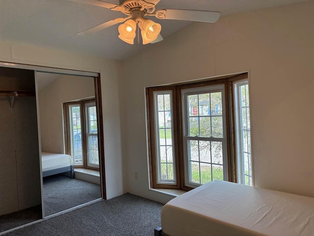 carpeted bedroom with ceiling fan and a closet