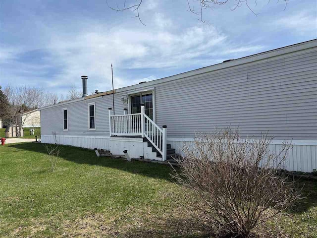 rear view of property featuring a yard