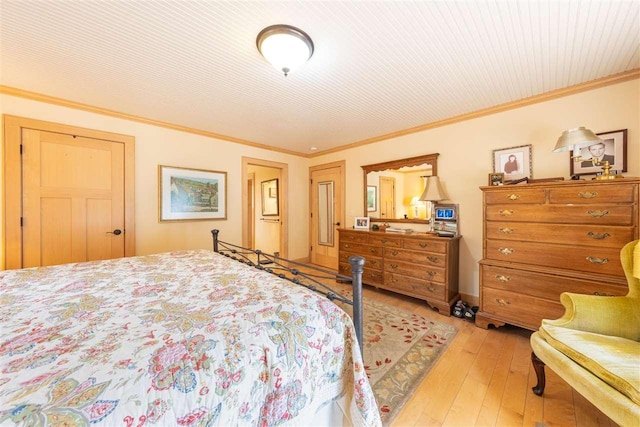 bedroom with ornamental molding and light wood-style flooring