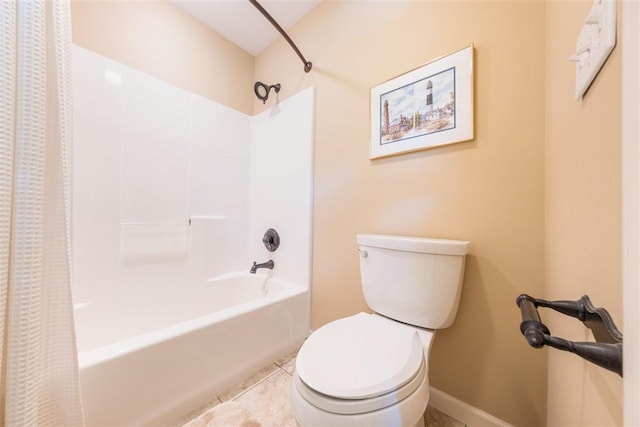 bathroom with tile patterned flooring, baseboards, shower / bath combo, and toilet