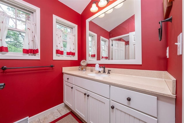 bathroom featuring tile patterned floors, visible vents, baseboards, and vanity