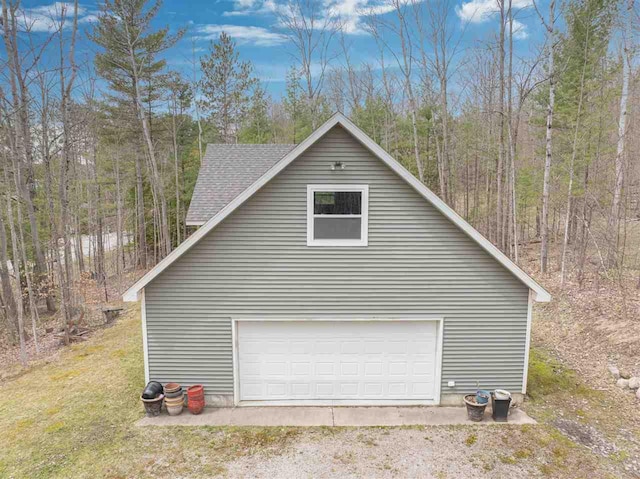detached garage with a wooded view