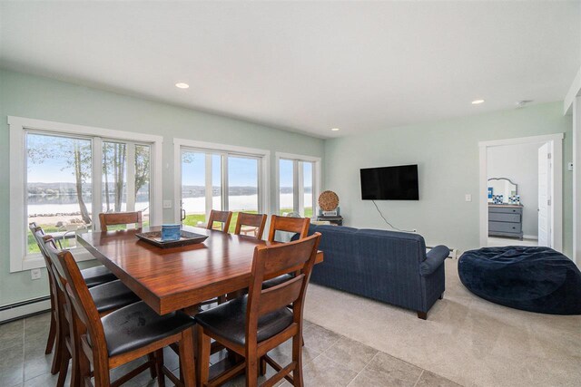 dining space featuring light tile patterned floors, a baseboard radiator, and recessed lighting