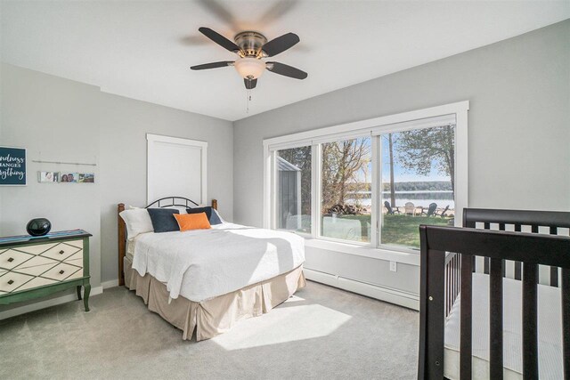carpeted bedroom with baseboards, a baseboard radiator, a water view, and ceiling fan