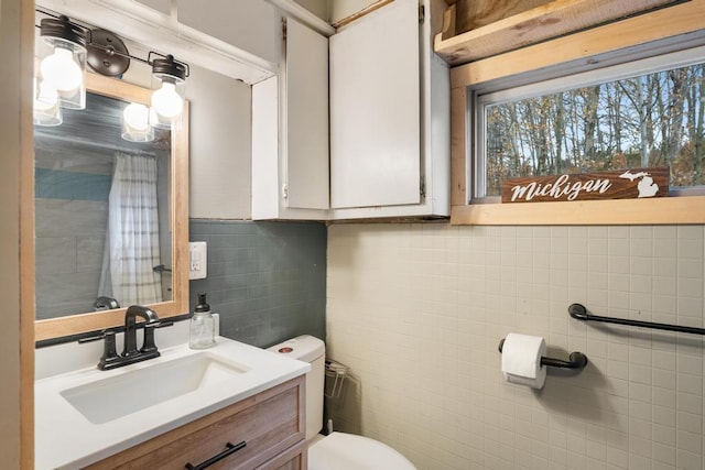 bathroom featuring vanity, toilet, tile walls, backsplash, and a shower with curtain