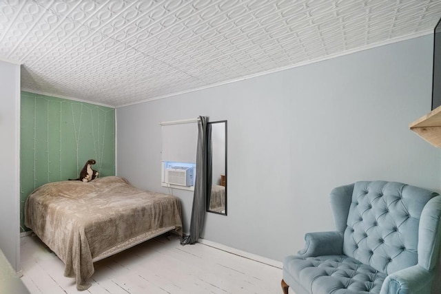 bedroom featuring crown molding, cooling unit, and an ornate ceiling