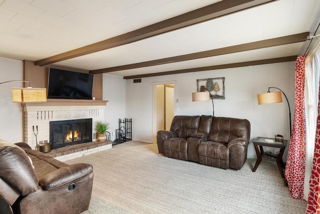 carpeted living area with visible vents, a brick fireplace, and beam ceiling