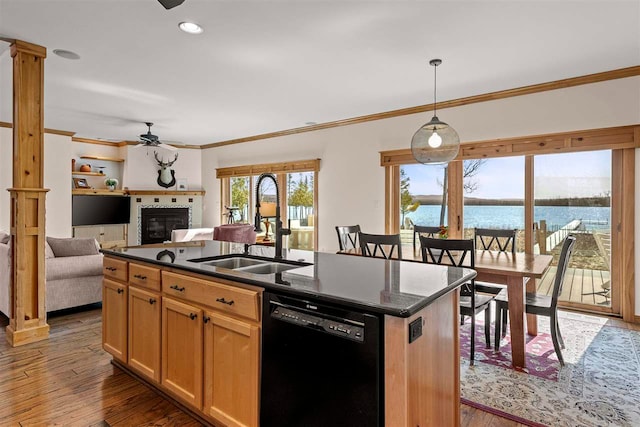 kitchen with a sink, a ceiling fan, black dishwasher, and dark countertops