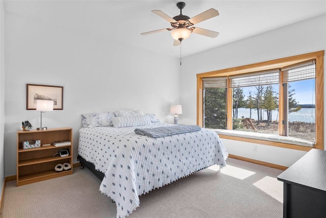 carpeted bedroom featuring baseboards and ceiling fan