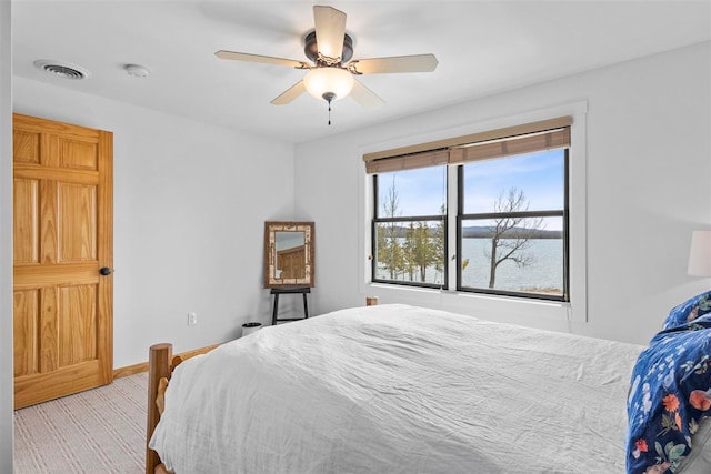 6650 S Beach Dr, Alanson, MI 49706 - bedroom featuring visible vents, carpet flooring, baseboards, and ceiling fan