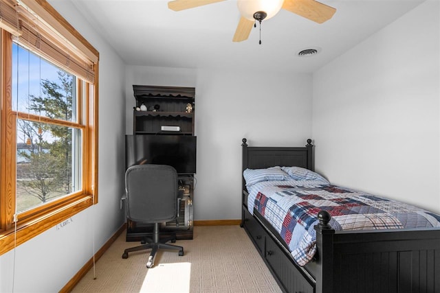 bedroom with baseboards, visible vents, and ceiling fan
