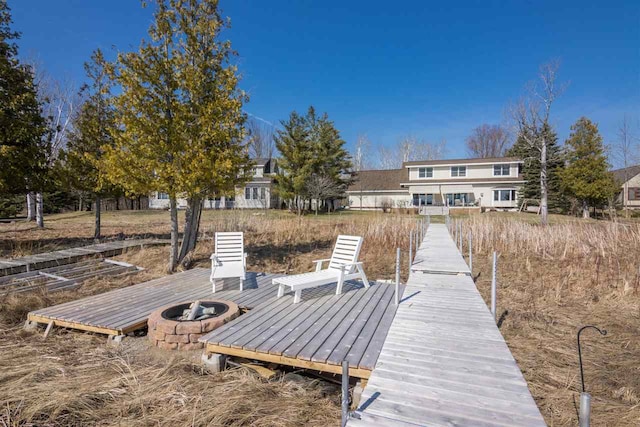 view of dock featuring an outdoor fire pit