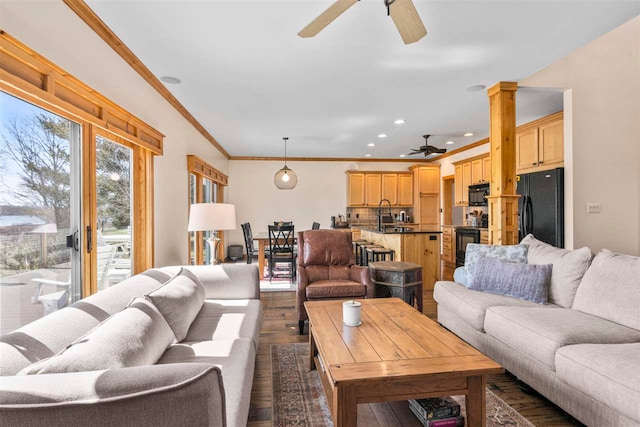 living room with a ceiling fan, dark wood finished floors, ornamental molding, and recessed lighting
