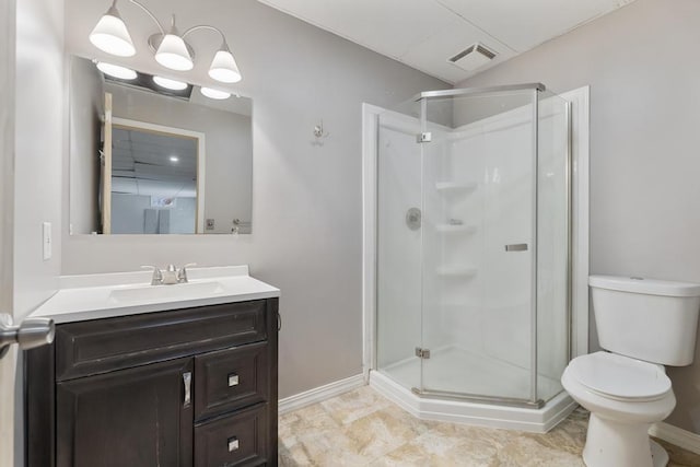 5748 Evergreen Trl, Petoskey, MI 49770 - full bathroom featuring visible vents, vanity, toilet, baseboards, and a shower stall