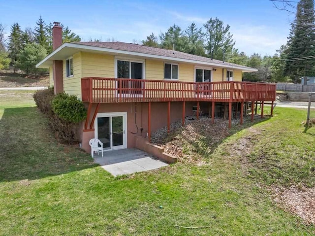 5748 Evergreen Trl, Petoskey, MI 49770 - back of house featuring a yard, a deck, and a chimney