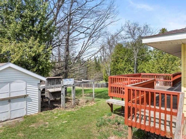 5748 Evergreen Trl, Petoskey, MI 49770 - view of yard featuring a wooden deck, an outdoor structure, and a storage unit