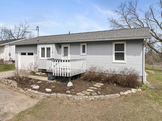 204 Winfield Ave, Petoskey, MI 49770 - exterior space featuring an attached garage, a shingled roof, driveway, and a deck
