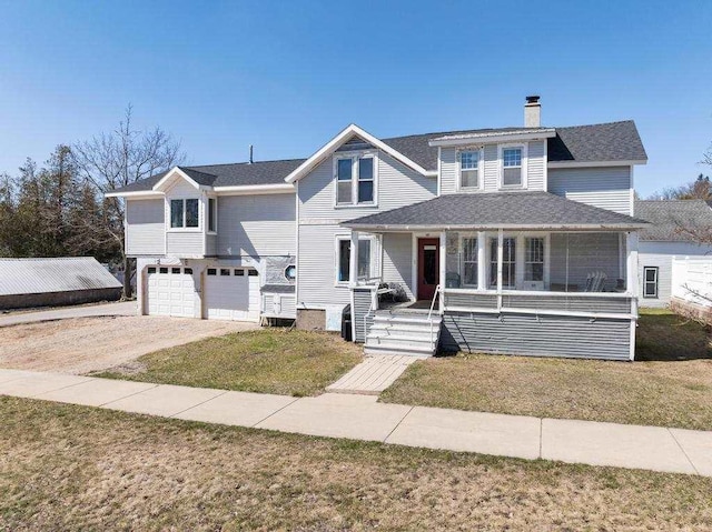 view of front of property featuring a front lawn, a garage, a chimney, covered porch, and driveway