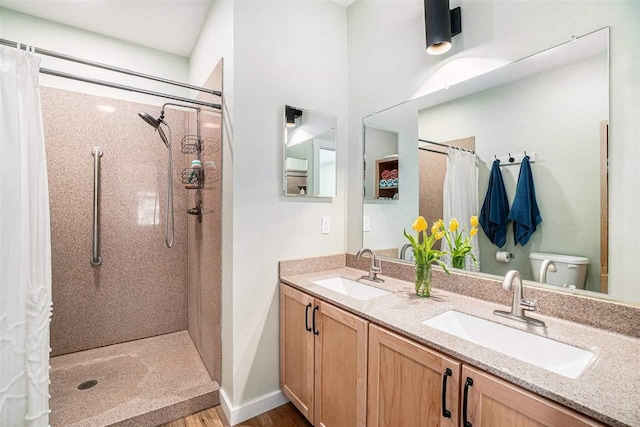 4852 Six Mile Lake Rd, Ellsworth, MI 49729 - bathroom featuring a sink, double vanity, curtained shower, and wood finished floors
