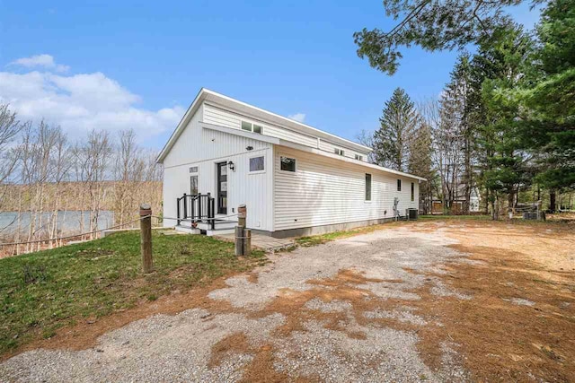 4852 Six Mile Lake Rd, Ellsworth, MI 49729 - shotgun-style home featuring central AC unit