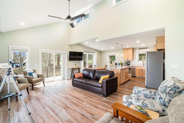 4852 Six Mile Lake Rd, Ellsworth, MI 49729 - living room with recessed lighting, ceiling fan, light wood-style flooring, and a towering ceiling