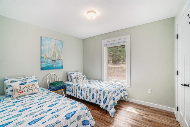 4852 Six Mile Lake Rd, Ellsworth, MI 49729 - bedroom with baseboards and wood finished floors