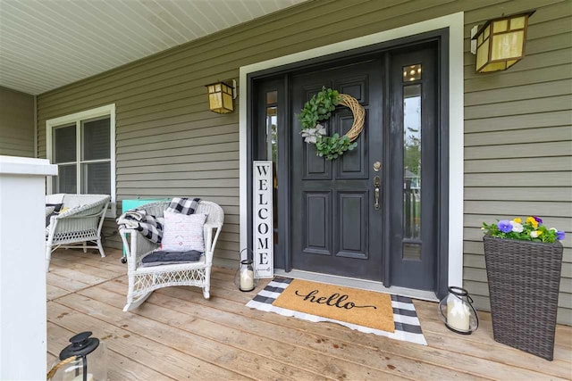 view of exterior entry with covered porch