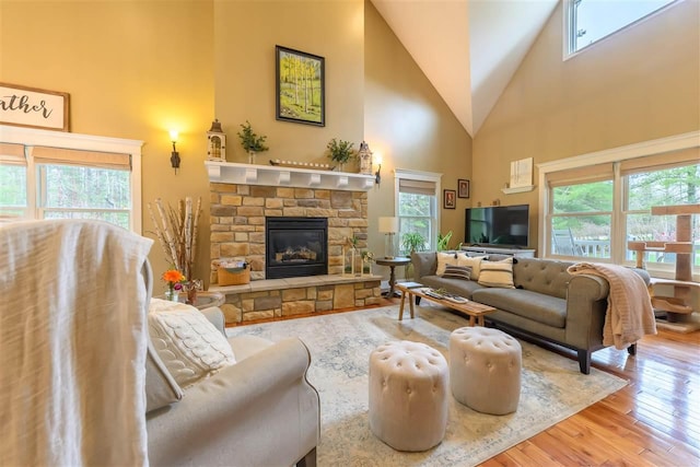 living room featuring a wealth of natural light, high vaulted ceiling, and hardwood / wood-style flooring