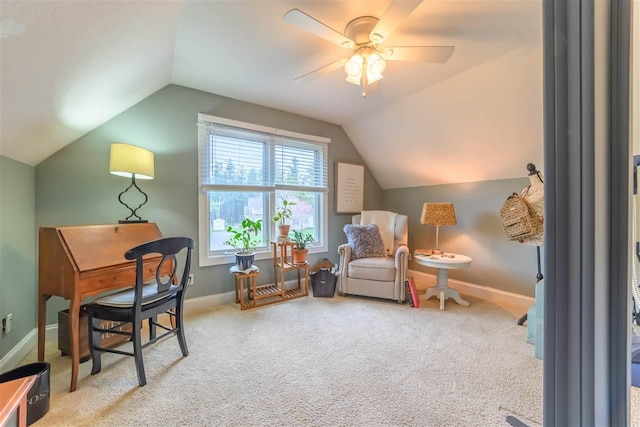 living area featuring lofted ceiling, carpet flooring, a ceiling fan, and baseboards