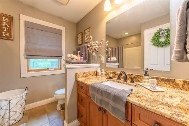 bathroom featuring toilet, vanity, tile patterned flooring, a shower with shower curtain, and baseboards
