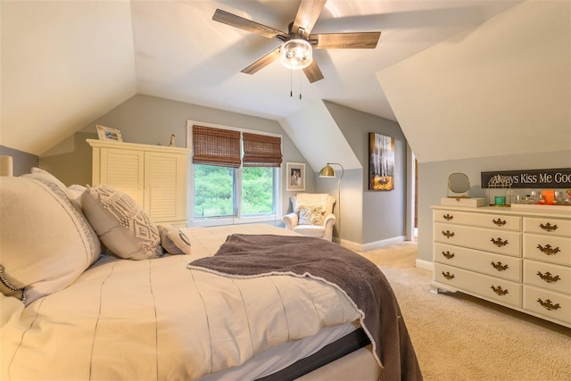 bedroom featuring light colored carpet, a ceiling fan, baseboards, and lofted ceiling