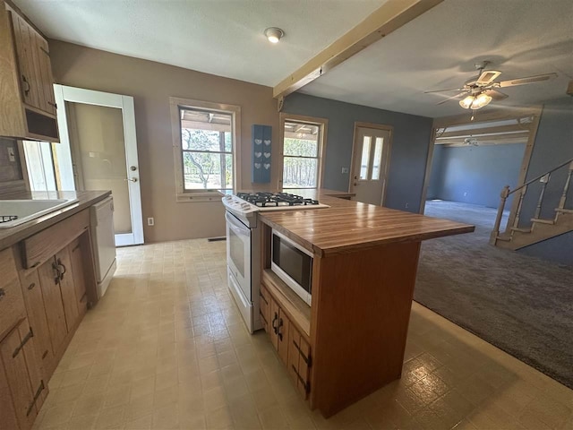 4445 Howard Rd, Petoskey, MI 49770 - kitchen featuring a ceiling fan, a center island, white appliances, butcher block counters, and a sink