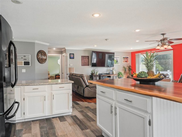 7906 Ferry Rd, East Jordan, MI 49727 - kitchen featuring white cabinetry, dark wood-style flooring, black refrigerator with ice dispenser, and a ceiling fan