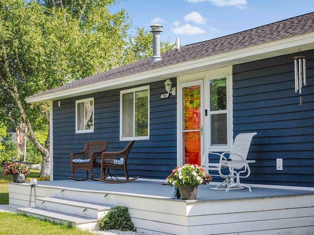 7906 Ferry Rd, East Jordan, MI 49727 - back of house featuring covered porch