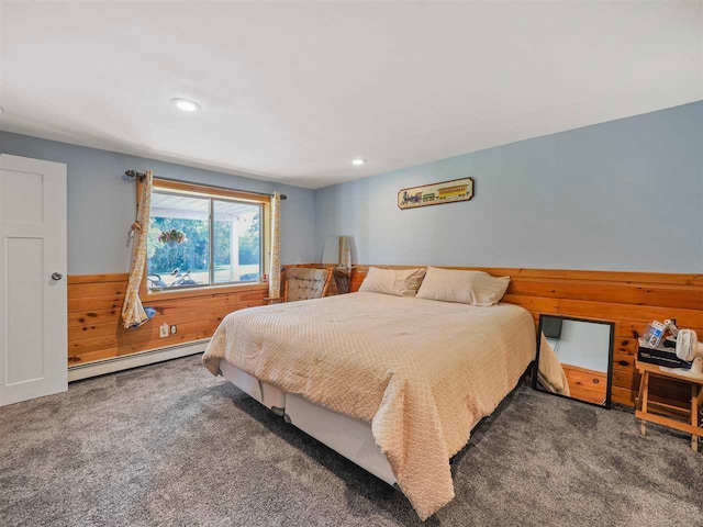 7906 Ferry Rd, East Jordan, MI 49727 - bedroom with recessed lighting, wood walls, a baseboard radiator, and carpet floors