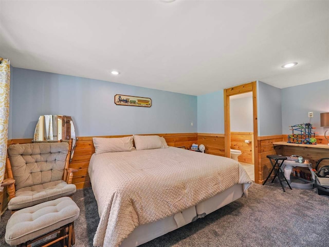 7906 Ferry Rd, East Jordan, MI 49727 - bedroom featuring wood walls, ensuite bathroom, a wainscoted wall, recessed lighting, and carpet floors