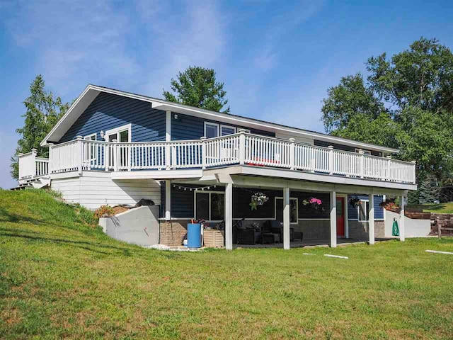 7906 Ferry Rd, East Jordan, MI 49727 - rear view of house featuring a wooden deck, a patio, and a lawn