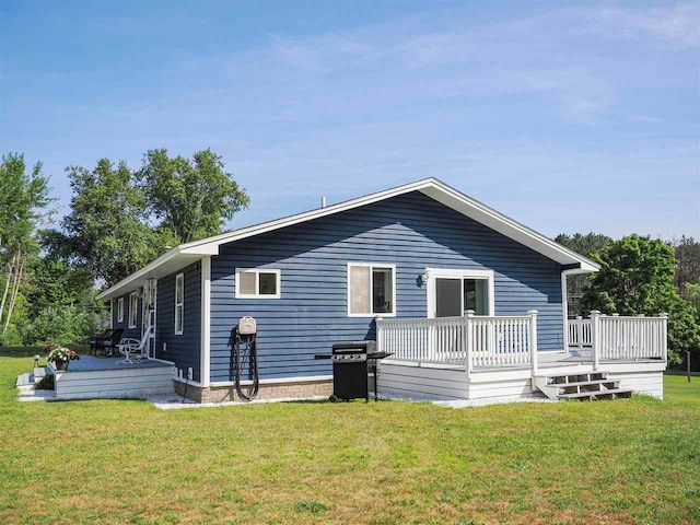 7906 Ferry Rd, East Jordan, MI 49727 - back of house with a yard and a wooden deck