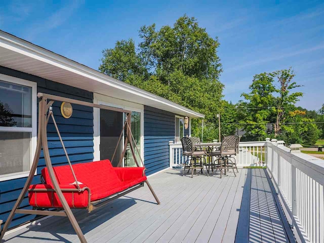 7906 Ferry Rd, East Jordan, MI 49727 - wooden deck featuring outdoor dining area