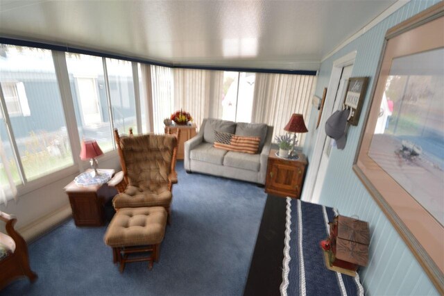 sunroom / solarium featuring carpet flooring, crown molding, and wallpapered walls