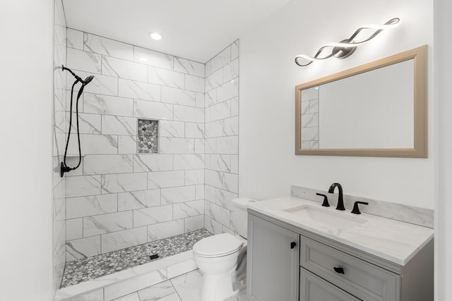 358 Harbor View Ln, Petoskey, MI 49770 - full bath featuring a tile shower, marble finish floor, vanity, and toilet