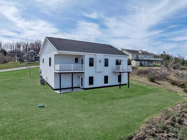 358 Harbor View Ln, Petoskey, MI 49770 - back of house featuring a yard, central AC unit, and a balcony