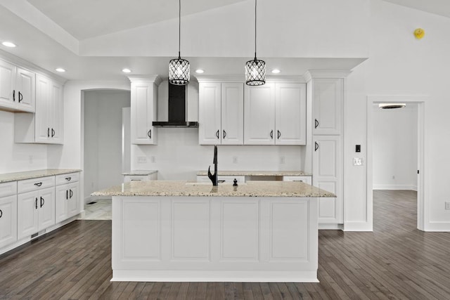 358 Harbor View Ln, Petoskey, MI 49770 - kitchen with white cabinetry, dark wood-style flooring, wall chimney range hood, lofted ceiling, and recessed lighting