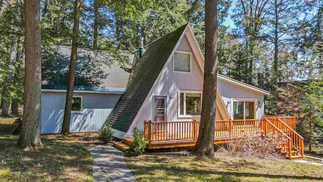 4488 Fourth St, Walloon Lake, MI 49796 - view of front of home with a wooden deck and a shingled roof