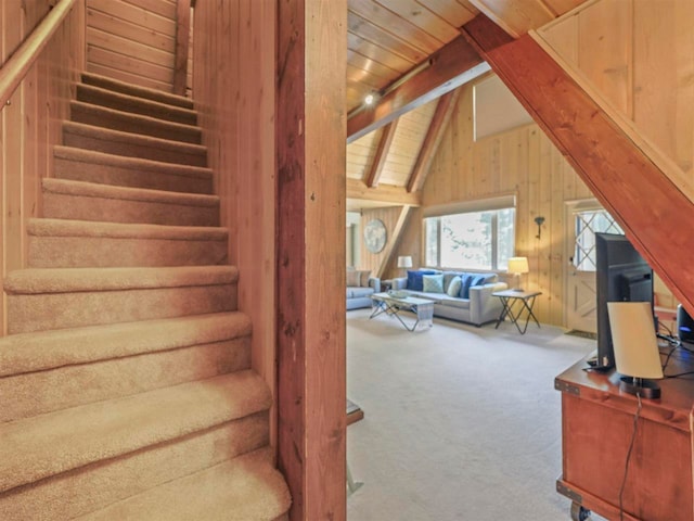 4488 Fourth St, Walloon Lake, MI 49796 - stairs with wooden ceiling, wood walls, carpet, and vaulted ceiling with beams