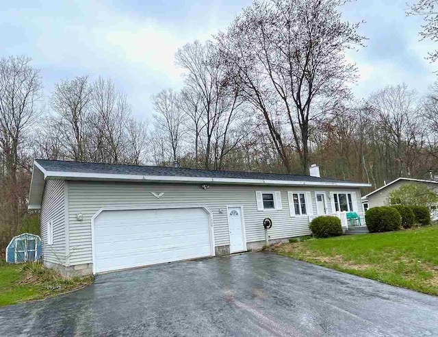 1368 S M-88, Bellaire, MI 49615 - ranch-style home with a chimney, driveway, a front lawn, and an attached garage