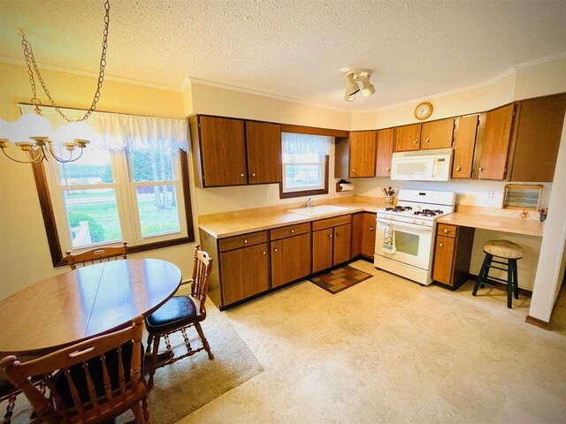 1368 S M-88, Bellaire, MI 49615 - kitchen featuring a textured ceiling, brown cabinets, a sink, and white appliances